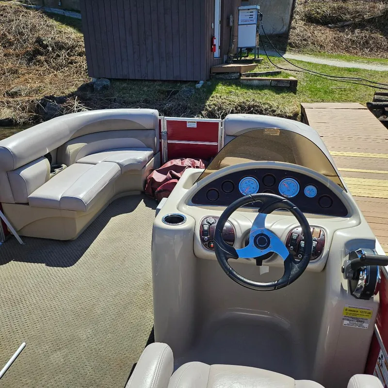 Slide: The Image of 2018 Starcraft EX 18 C boat interior with steering wheel and seating area. - 3