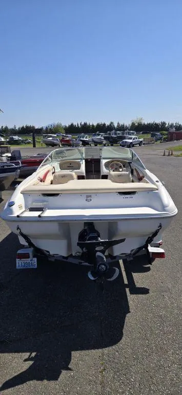 Slide: The Image of 1999 Sea Ray 185 Bow Rider boat parked outdoors on a sunny day. - 3
