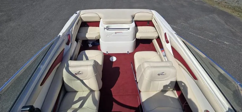 Slide: The Image of 1999 Sea Ray 185 Bow Rider interior with beige seats and red carpet. - 4