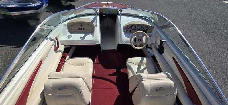 Slide: The Image of 1999 Sea Ray 185 Bow Rider interior with cream seats and red carpet. - 5