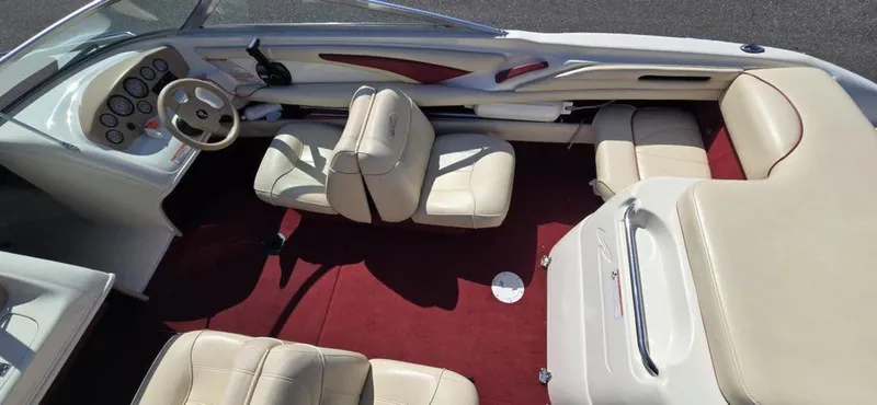 Slide: The Image of 1999 Sea Ray 185 Bow Rider interior with beige seats and red carpet. - 6