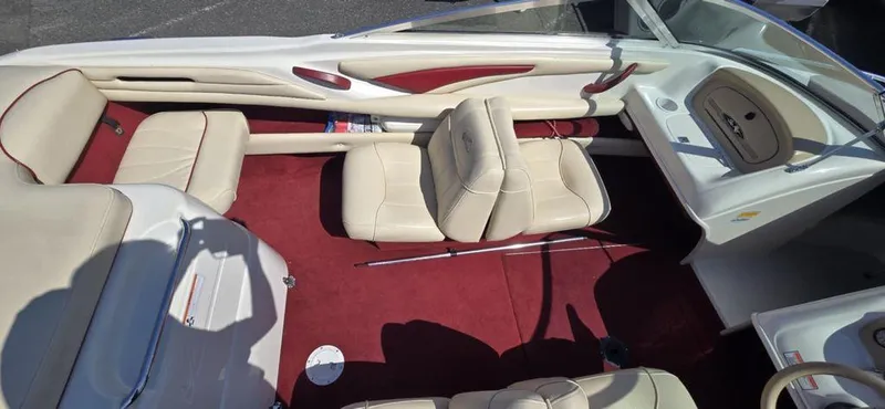 Slide: The Image of 1999 Sea Ray 185 Bow Rider interior with beige seats and red carpet. - 7