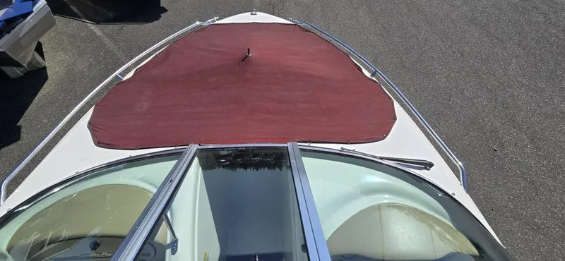 Slide: The Image of 1999 Sea Ray 185 Bow Rider with red cover, viewed from above. - 8