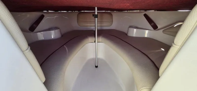 Slide: The Image of 1999 Sea Ray 185 Bow Rider interior with cushioned seating and storage compartments. - 9