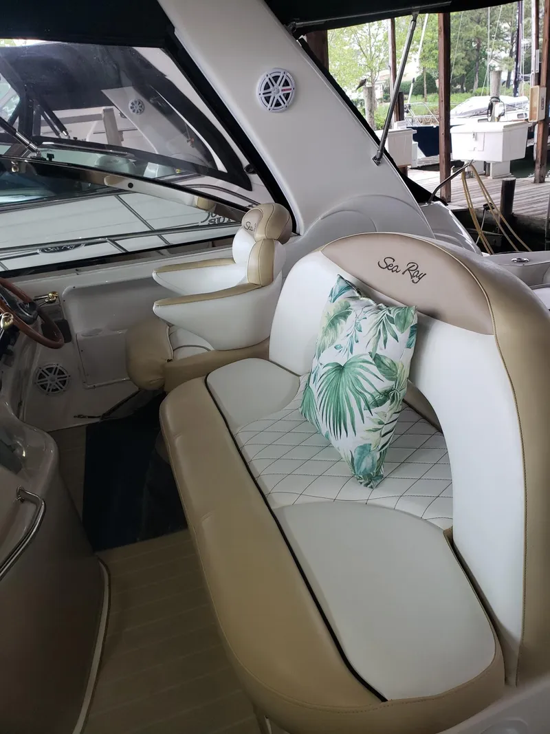Slide: The Image of 2001 Sea Ray 410 Sundancer interior with beige seating and tropical pillow. - 12