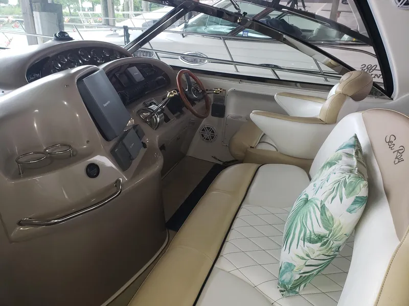Slide: The Image of Interior of 2001 Sea Ray 410 Sundancer yacht with plush seating and modern dashboard. - 13
