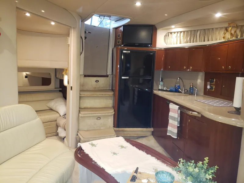 Slide: The Image of Luxurious interior of 2001 Sea Ray 410 Sundancer yacht with kitchen and seating area. - 15