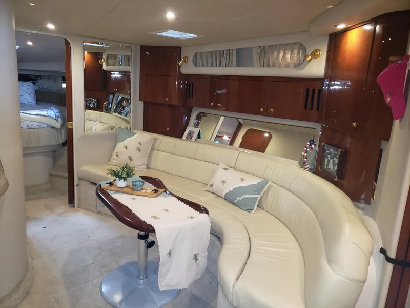 Slide: The Image of Luxurious interior of 2001 Sea Ray 410 Sundancer yacht with elegant seating and decor. - 16