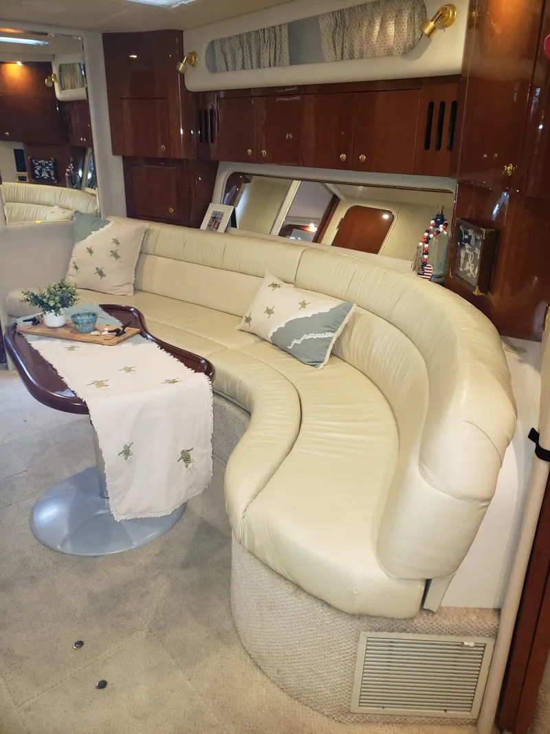 Slide: The Image of Luxurious interior of 2001 Sea Ray 410 Sundancer yacht with elegant curved seating. - 17