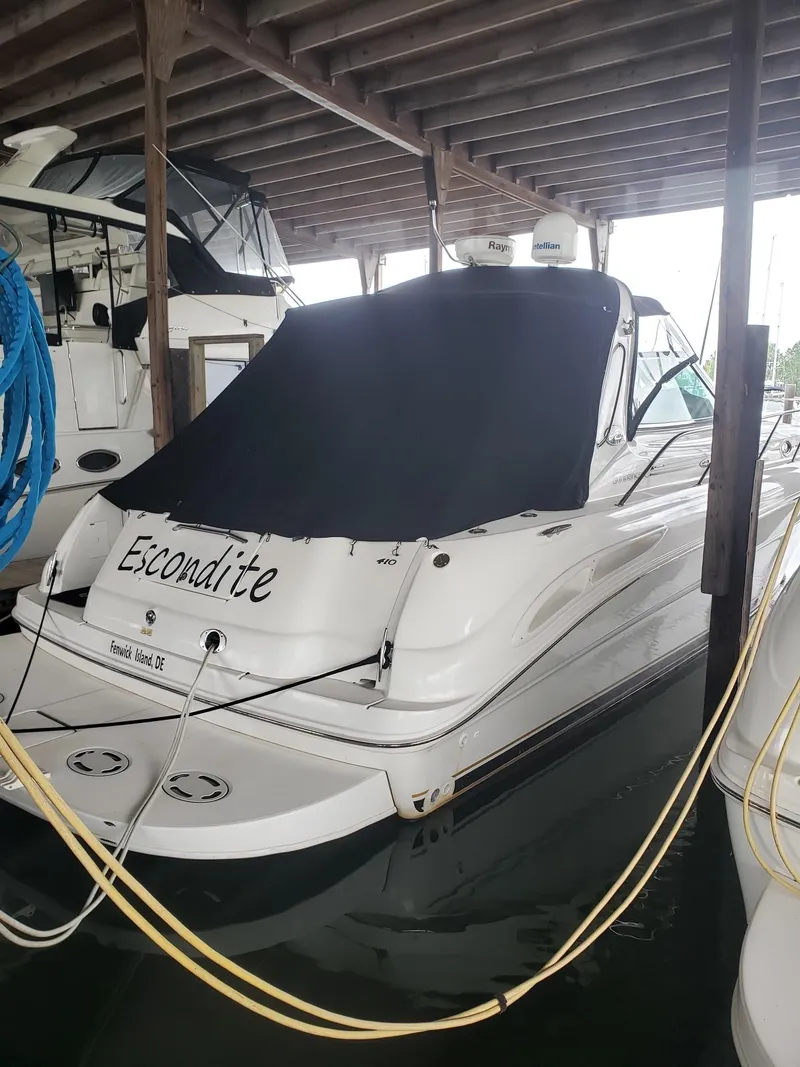 Slide: The Image of 2001 Sea Ray 410 Sundancer docked under cover, rear view with black cover. - 2