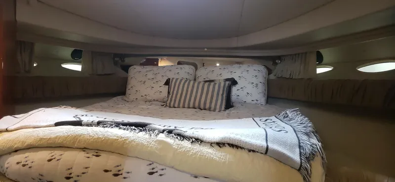 Slide: The Image of Cozy cabin interior of 2001 Sea Ray 410 Sundancer with plush bedding. - 20