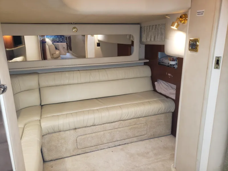 Slide: The Image of Interior of 2001 Sea Ray 410 Sundancer with beige leather seating and wall mirror. - 24