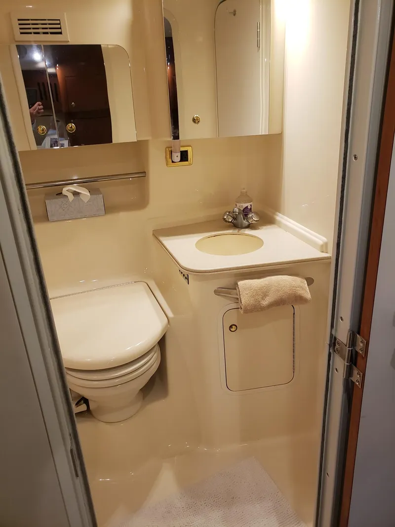 Slide: The Image of 2001 Sea Ray 410 Sundancer bathroom with toilet, sink, and mirror. - 26