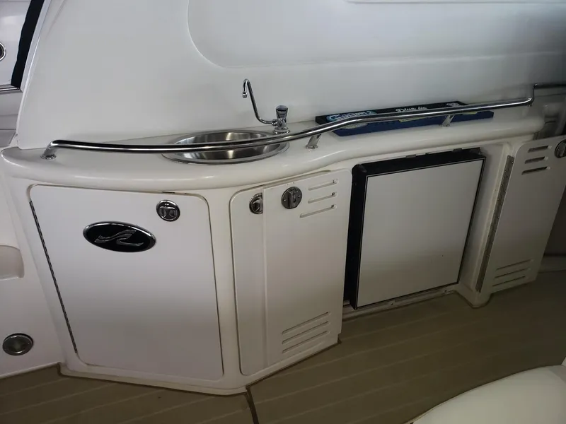 Slide: The Image of 2001 Sea Ray 410 Sundancer yacht kitchenette with sink and storage cabinets. - 28