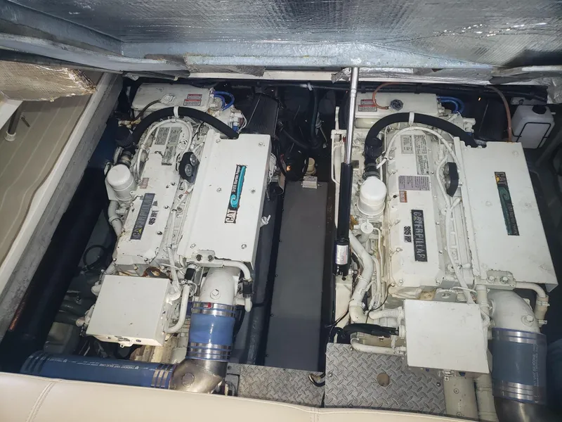 Slide: The Image of Engine compartment of a 2001 Sea Ray 410 Sundancer boat, featuring dual engines. - 30