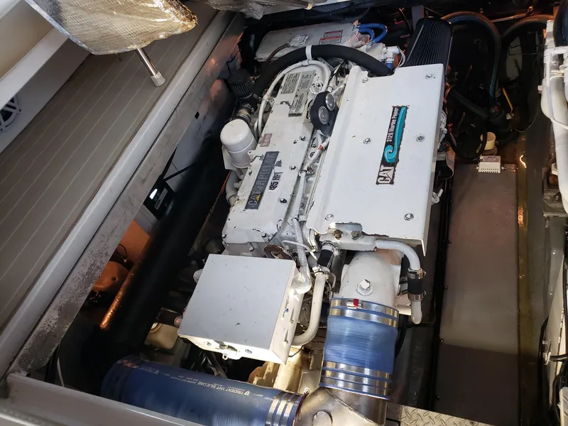 Slide: The Image of Engine compartment of a 2001 Sea Ray 410 Sundancer boat, showcasing detailed machinery. - 31