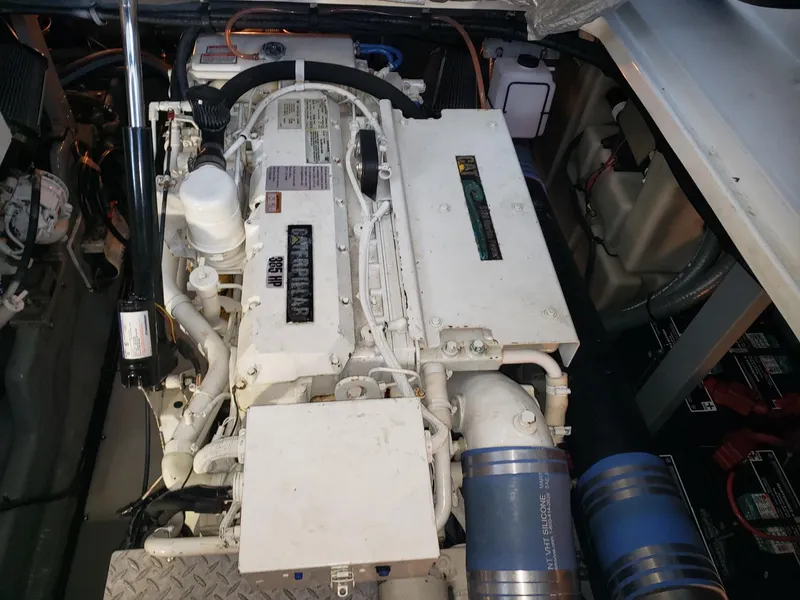 Slide: The Image of Engine compartment of a 2001 Sea Ray 410 Sundancer boat, showcasing detailed machinery. - 32