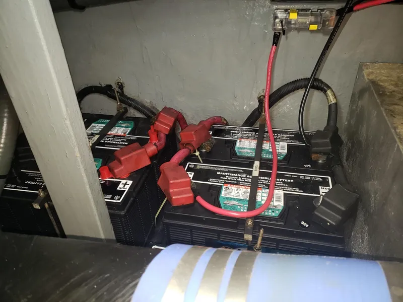 Slide: The Image of Battery compartment of a 2001 Sea Ray 410 Sundancer boat with connected cables. - 35
