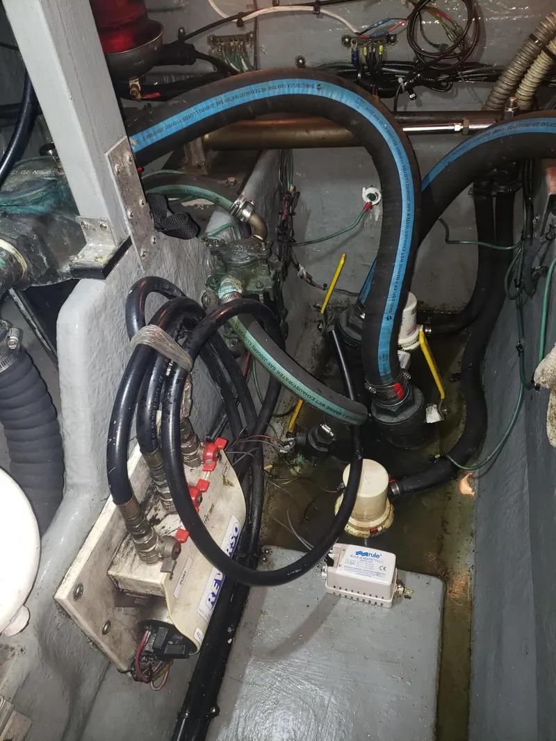 Slide: The Image of Engine compartment of a 2001 Sea Ray 410 Sundancer with visible hoses and wiring. - 36