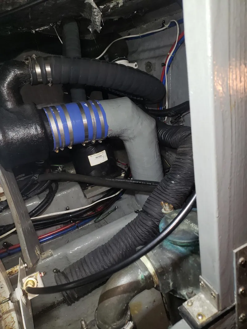 Slide: The Image of Engine compartment of a 2001 Sea Ray 410 Sundancer with visible hoses and wiring. - 37