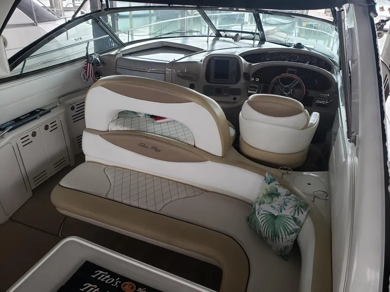 Slide: The Image of 2001 Sea Ray 410 Sundancer cockpit with beige seating and modern dashboard. - 5