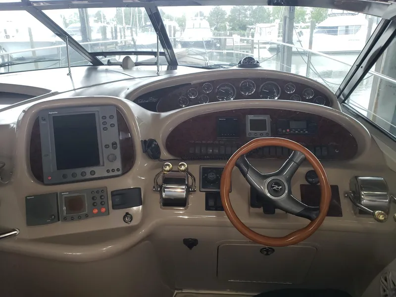 Slide: The Image of 2001 Sea Ray 410 Sundancer helm with navigation instruments and steering wheel. - 7