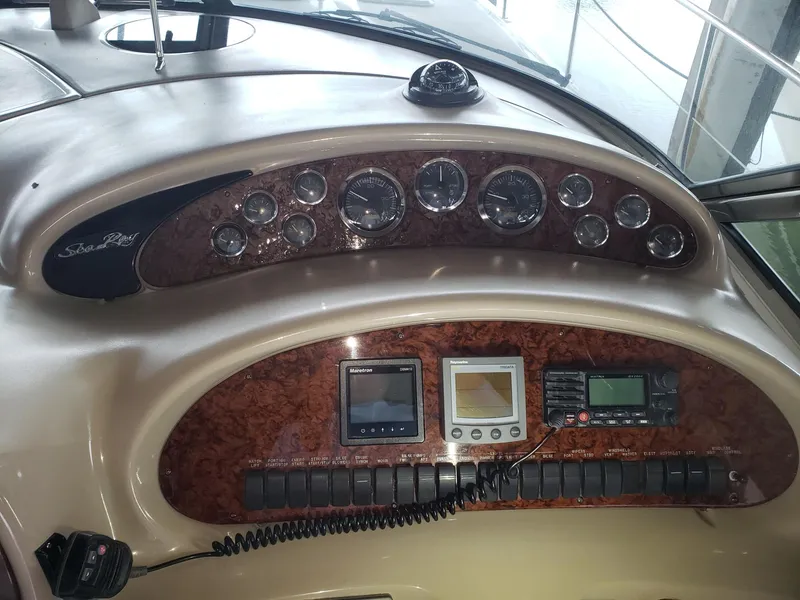 Slide: The Image of Dashboard of a 2001 Sea Ray 410 Sundancer boat with gauges and navigation equipment. - 8