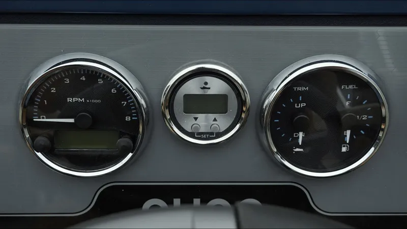 Slide: The Image of Dashboard of 2025 Tahoe Pontoon Aura 2185, featuring RPM, trim, and fuel gauges. - 11