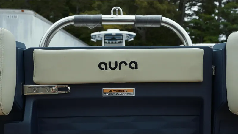 Slide: The Image of 2025 Tahoe Pontoon Aura 2185 Quad Lounger Triple, rear view with logo and safety warning. - 17