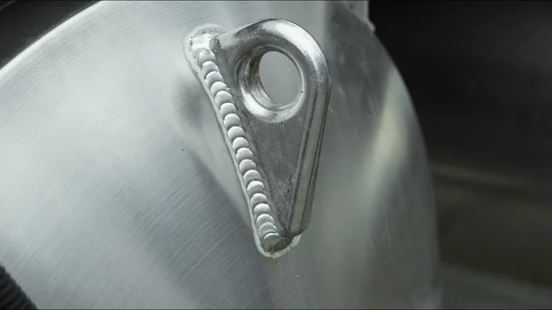 Slide: The Image of Close-up of a welded metal component on a 2025 Tahoe Pontoon Aura 2185. - 24