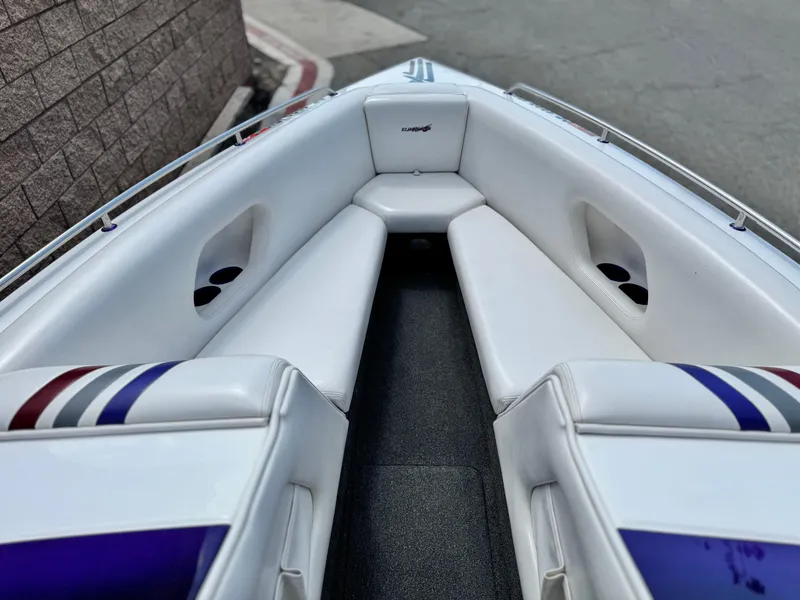 Slide: The Image of 2005 Eliminator Eagle 230 XP boat interior with white seating and colorful accents. - 10