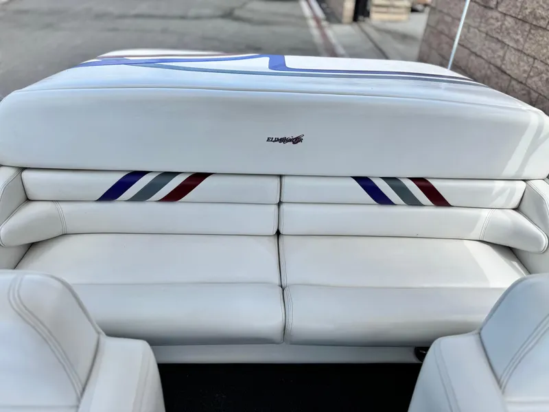 Slide: The Image of White leather seating in a 2005 Eliminator Eagle 230 XP boat, featuring colored accents. - 14