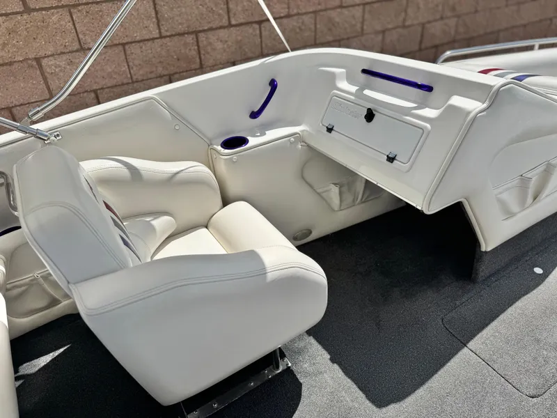 Slide: The Image of 2005 Eliminator Eagle 230 XP boat interior with white seating and storage compartments. - 17