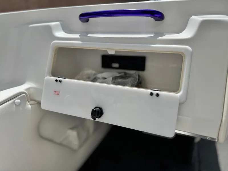 Slide: The Image of Open storage compartment in a 2005 Eliminator Eagle 230 XP boat interior. - 18