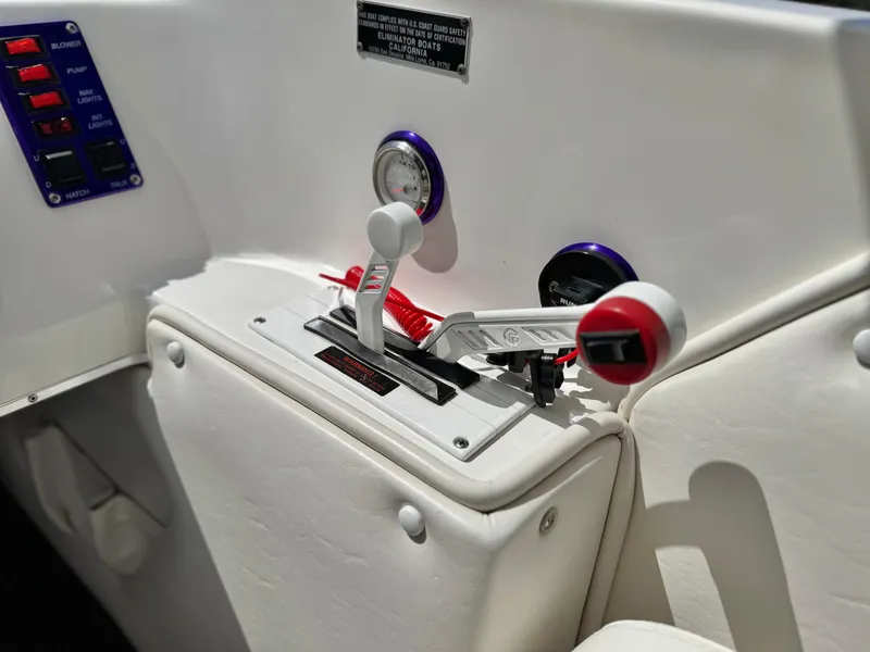 Slide: The Image of Control panel of 2005 Eliminator Eagle 230 XP boat with throttle levers and gauges. - 24