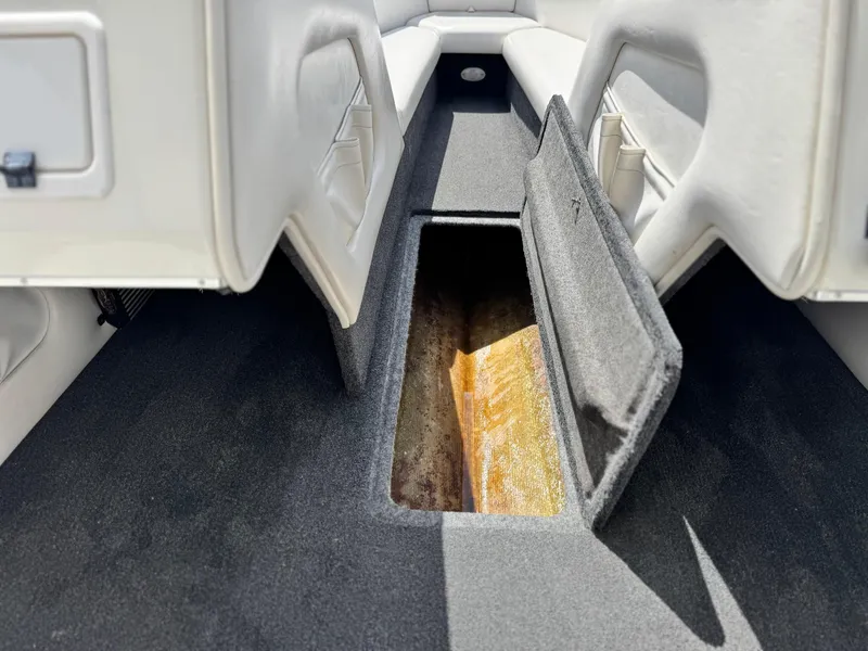 Slide: The Image of Open storage compartment in 2005 Eliminator Eagle 230 XP boat interior. - 25