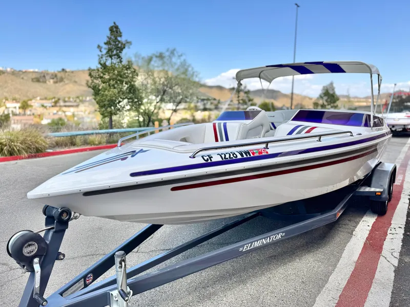 Slide: The Image of 2005 Eliminator Eagle 230 XP speedboat on trailer, parked outdoors. - 3