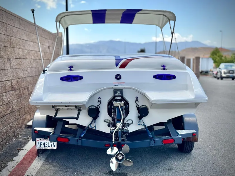 Slide: The Image of 2005 Eliminator Eagle 230 XP boat on trailer, rear view, with canopy and propeller visible. - 4