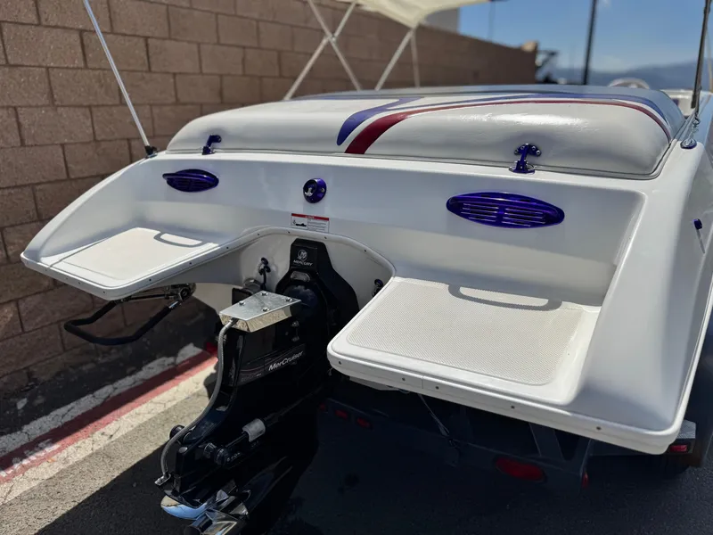 Slide: The Image of 2005 Eliminator Eagle 230 XP boat rear view with swim platforms and outboard motor. - 6
