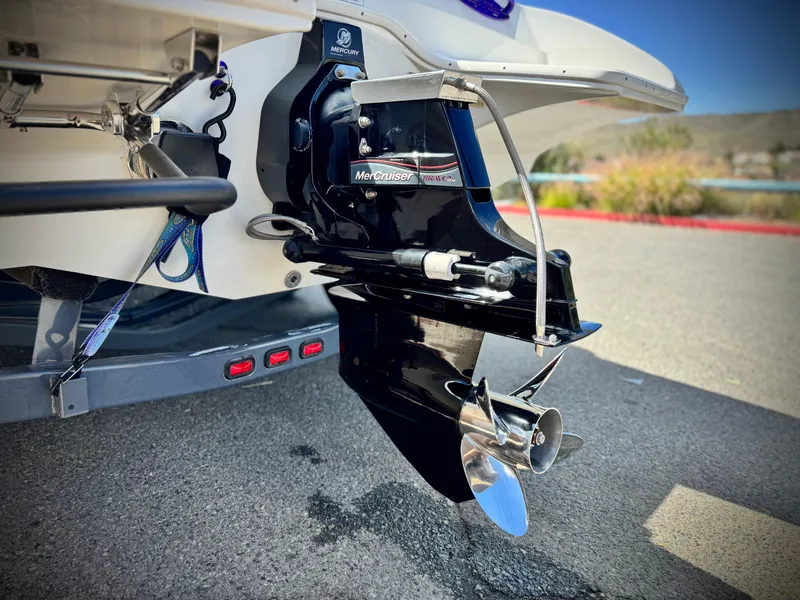 Slide: The Image of 2005 Eliminator Eagle 230 XP boat with MerCruiser outdrive, parked on pavement. - 7