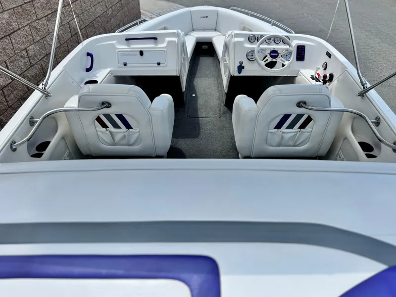 Slide: The Image of 2005 Eliminator Eagle 230 XP boat interior with white seating and steering console. - 8