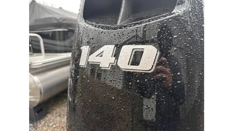 Slide: The Image of Close-up of a wet 140 horsepower engine on a 2025 Tahoe Pontoon Sport 85 Quad Lounger. - 6