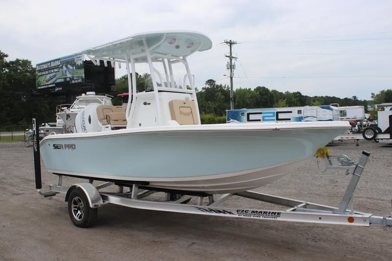 Slide: The Image of 2025 Sea Pro 202 CC boat on trailer, parked outdoors. - 1