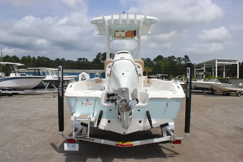 Slide: The Image of 2025 Sea Pro 202 CC boat, rear view, on trailer, in a marina setting. - 11