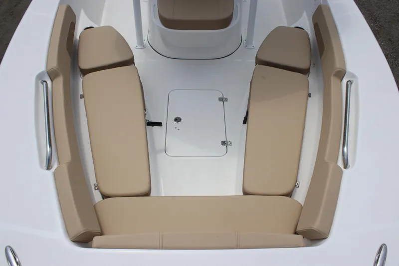 Slide: The Image of 2025 Sea Pro 202 CC boat interior with beige cushioned seating and storage hatch. - 15