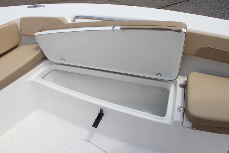 Slide: The Image of Open storage compartment on 2025 Sea Pro 202 CC boat with beige seating. - 18