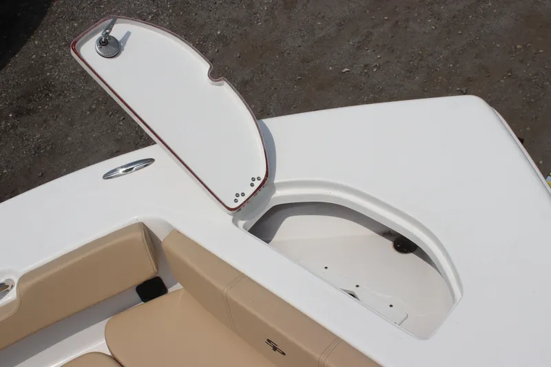 Slide: The Image of 2025 Sea Pro 202 CC boat with open storage compartment and beige seating. - 22