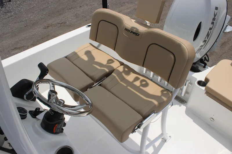 Slide: The Image of 2025 Sea Pro 202 CC boat interior with beige seating and steering wheel. - 24