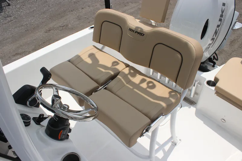 Slide: The Image of 2025 Sea Pro 202 CC boat helm with beige seating and steering wheel. - 25