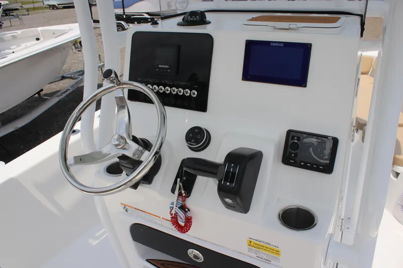Slide: The Image of 2025 Sea Pro 202 CC boat dashboard with steering wheel and electronic controls. - 29